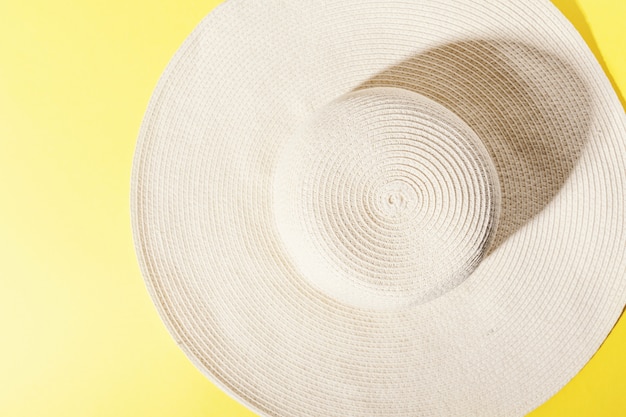 Free photo straw hat on bright yellow sunny background