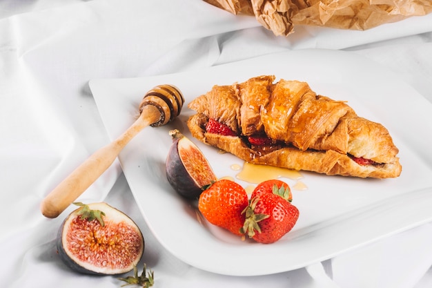 Free photo strawberry and fig near nice croissant