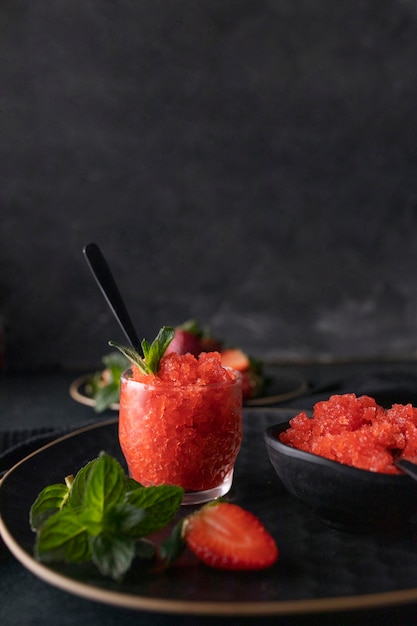 Strawberry granita dessert with mint high angle