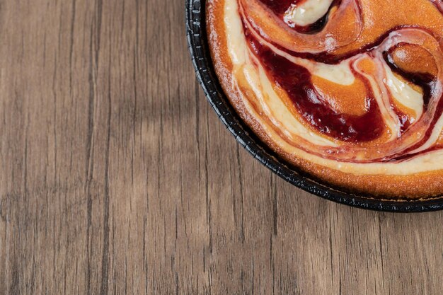 Strawberry pie on black metallic pan.