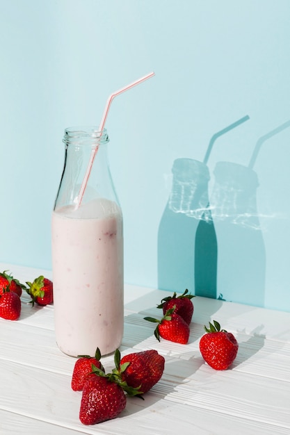 Strawberry pink smoothie in glass bottle 