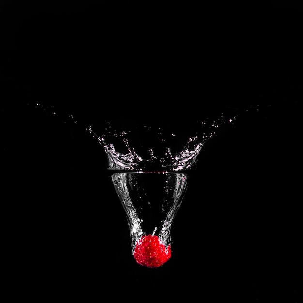 Strawberry plunging into the water