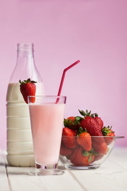 Strawberry smoothie on white wood