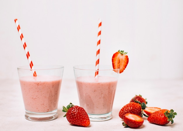 Strawberry smoothies in glasses with straws