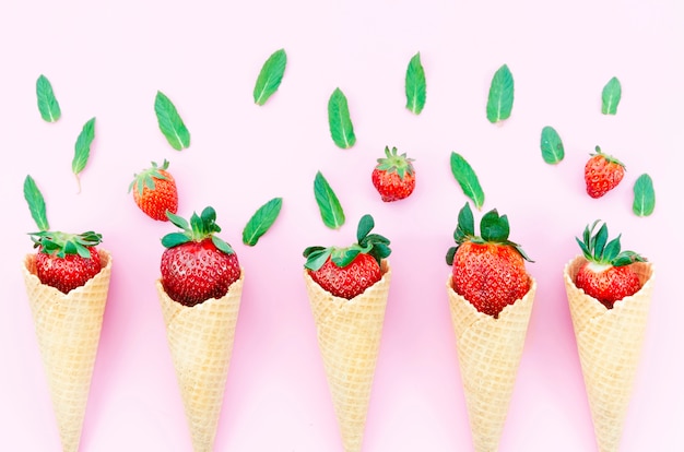 Strawberry in waffle cones for ice cream on light background