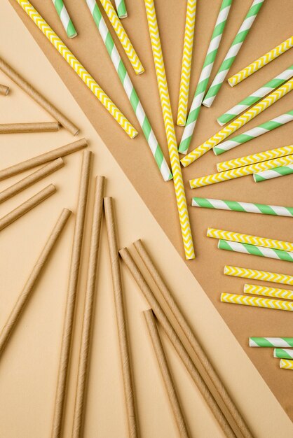 Straws in green and yellow colors flat lay