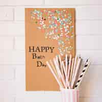 Free photo straws near cardboard with birthday greeting