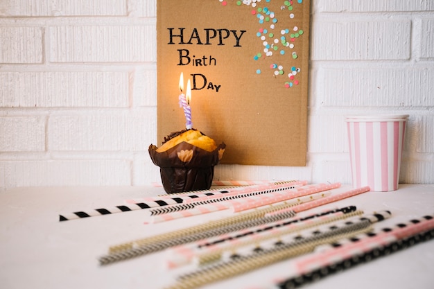 Free photo straws near muffin and birthday greeting