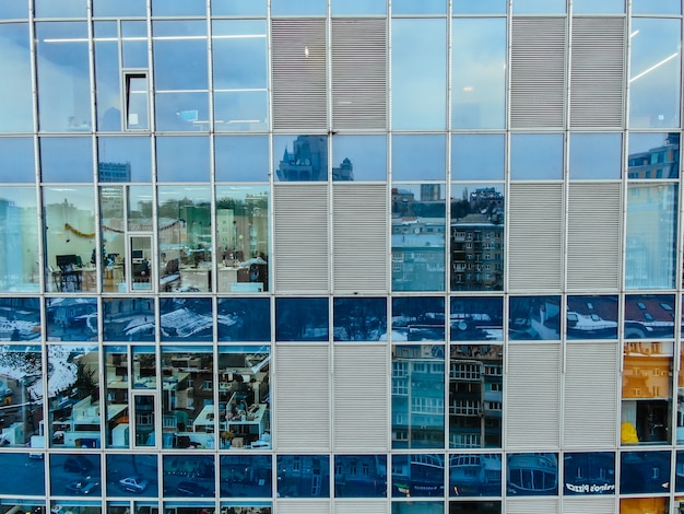 Free photo street reflection on glass steel building facade