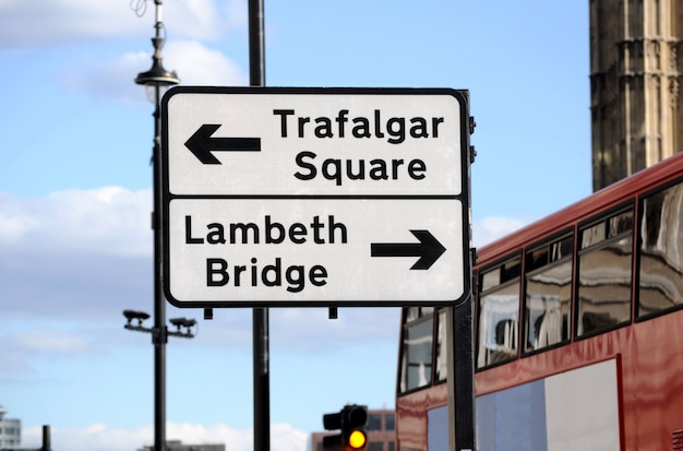 Free photo street sign and double decker bus in london