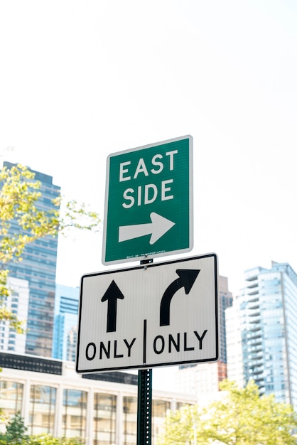 Street signs with blurred city background