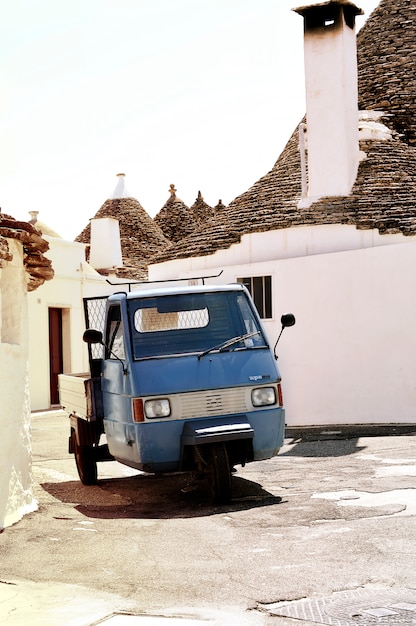 Street with a small blue car