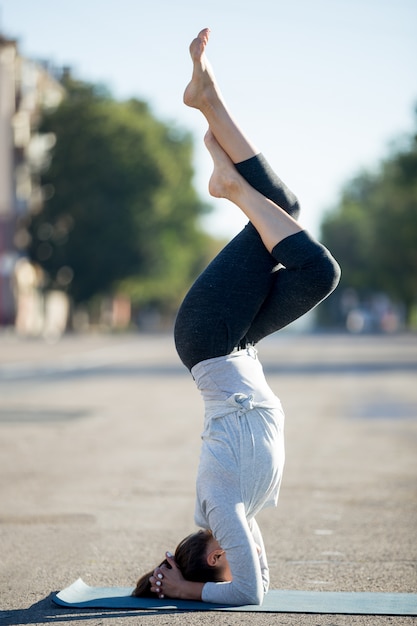 Free photo street yoga: salamba sirshasana with garudasana legs