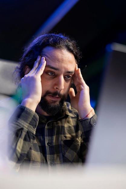 Free photo stressed person sits in front of laptop