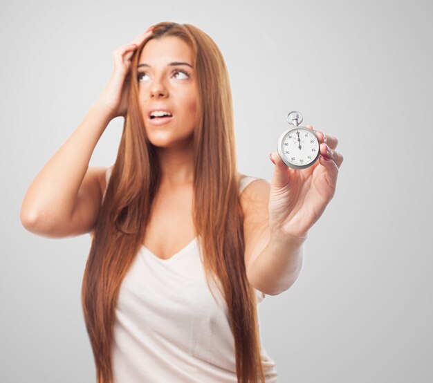 Stressed woman with stopwatch in hand