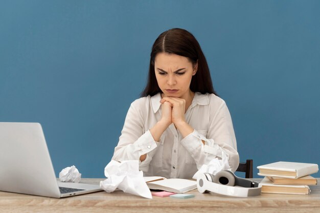 Stressed woman working on laptop