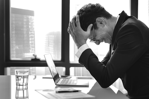 Stressed young businessman overworking