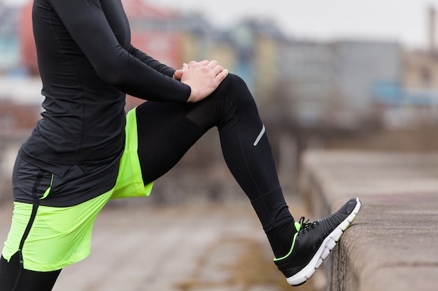 Free photo stretching leg on a rainy day