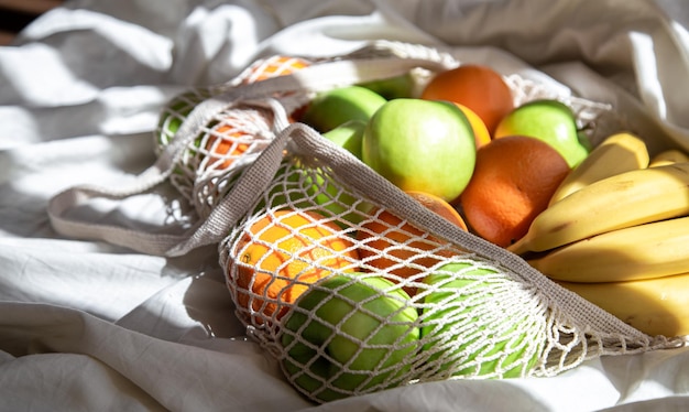 String bag with fruits in bed with sunbeams