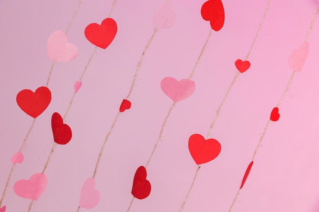 Strings composed of hearts on a pink background