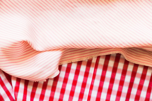 Striped folded fabric on red gingham garments