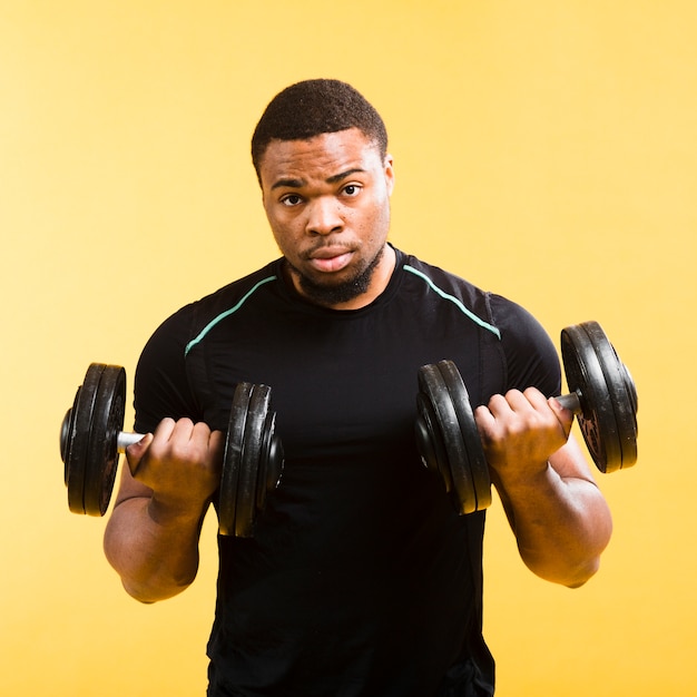 Strong athletic man holding weights