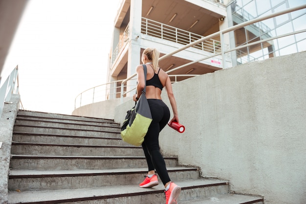 strong young sports woman on steps