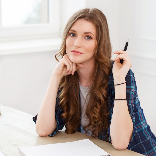 Student. Attractive girl by the table