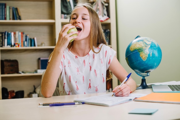 Free photo student girl biting apple