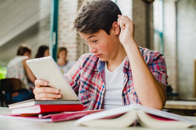 Student looking with puzzlement at tablet