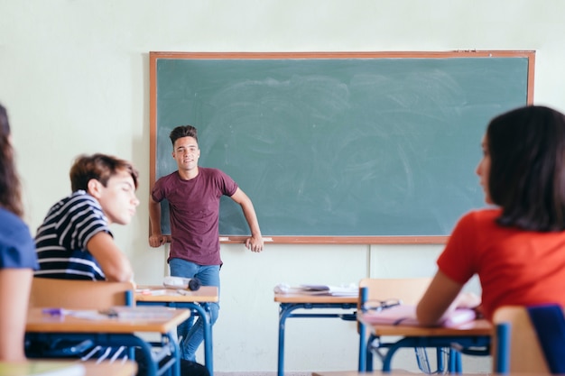 Student posing in front of the class