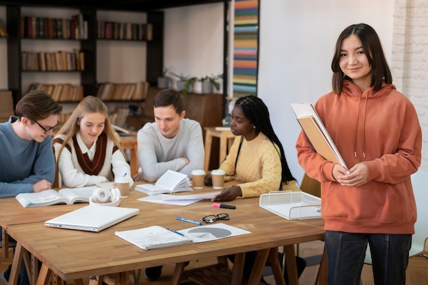 Student posing during a group study session with colleagues