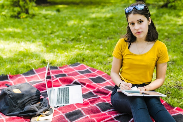 Student posing and writing