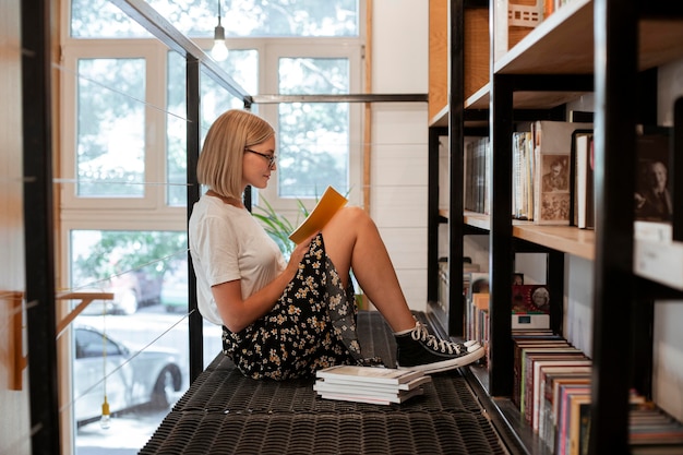 Free Photo student reading a book at the library