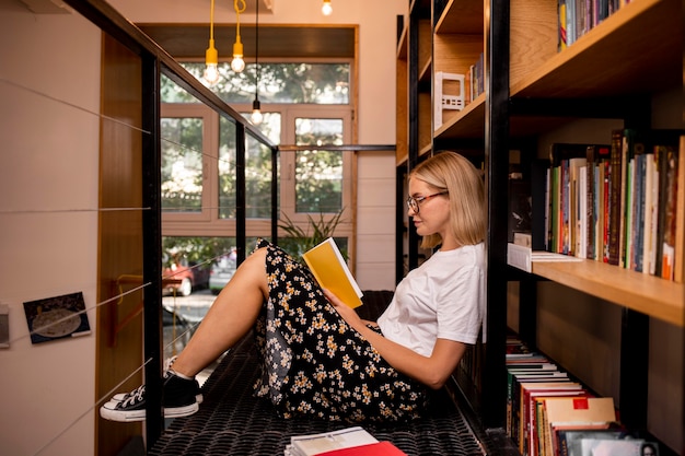 Student reading a book at the library