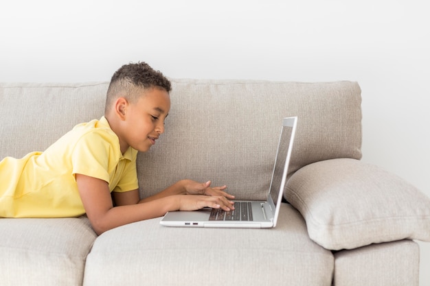 Student sitting on couch using laptop