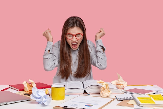 Student sitting at desk with documents