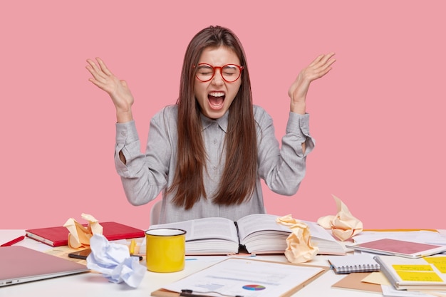 Student sitting at desk with documents