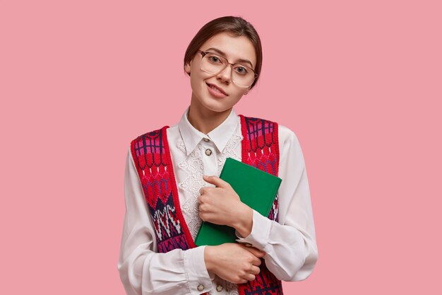 Student in vintage clothes holding book