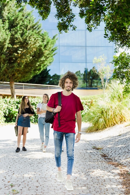 Student walking on campus with backpack 