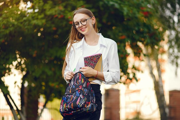 Student with a backpack on a school yard