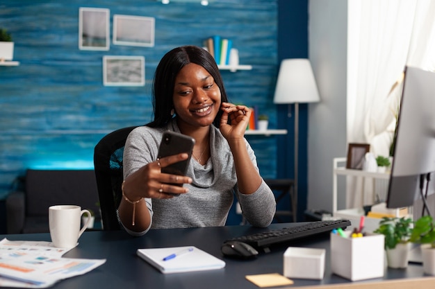 Student with dark skin discussing communication course with remote collegue during online videocall