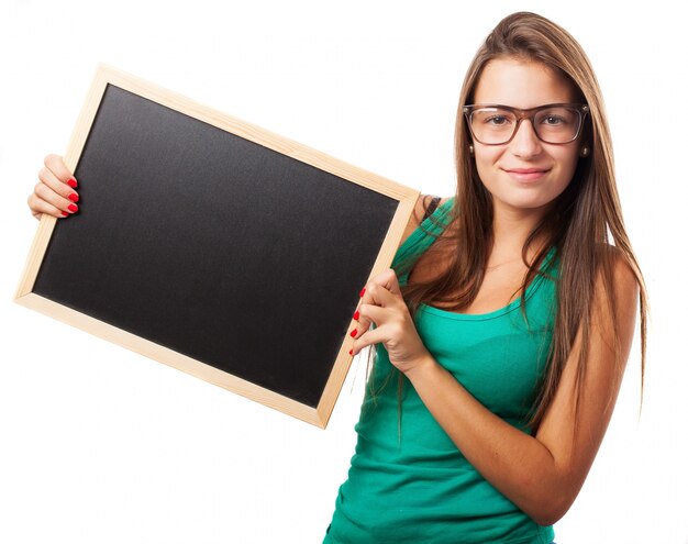 Student with glasses holding a chalkboard