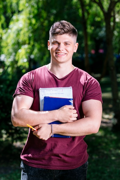 Free photo student with notebook and book in garden