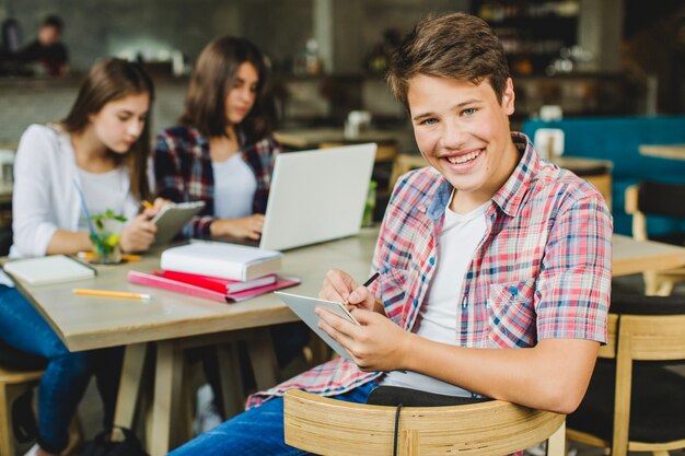 Student with table posing in cafe