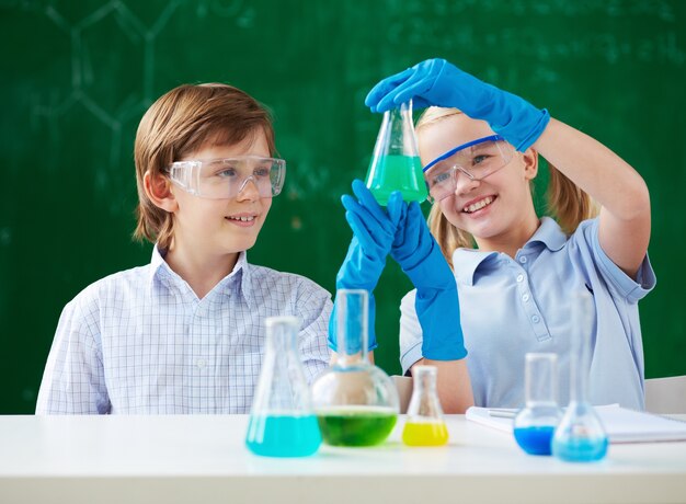 Students holding the flask with green liquid