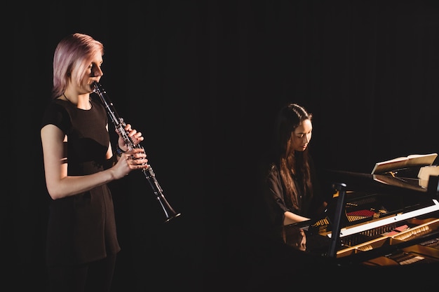 Students playing clarinet and piano