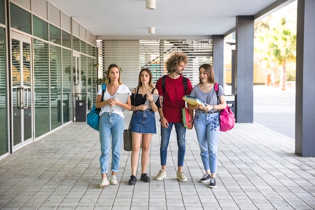 Free photo students standing near university building