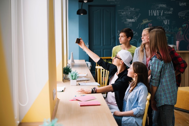 Free photo students taking selfie in class