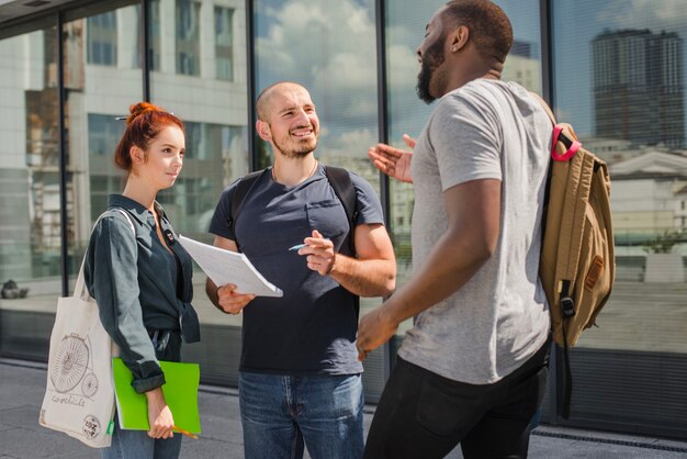 Students with papers talking